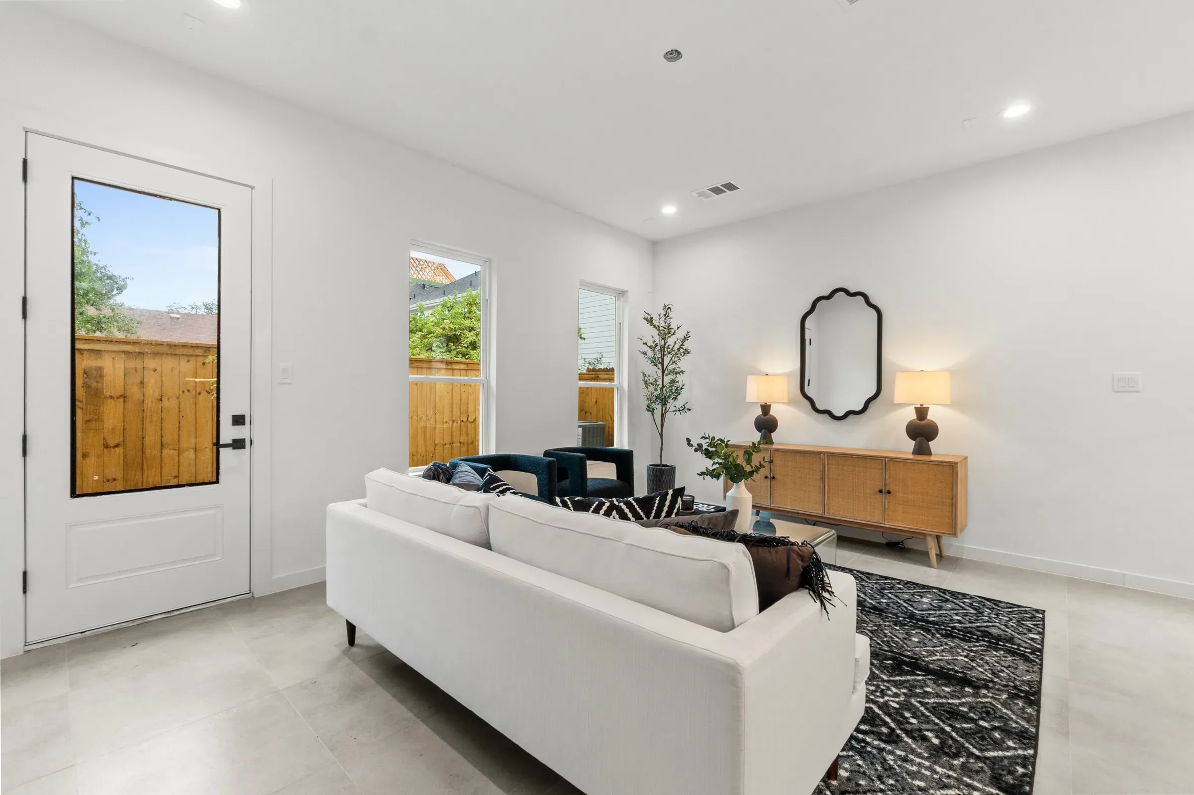 Bright living room with a white sofa and rattan console