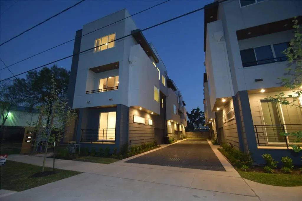 Heights townhomes lit at dusk